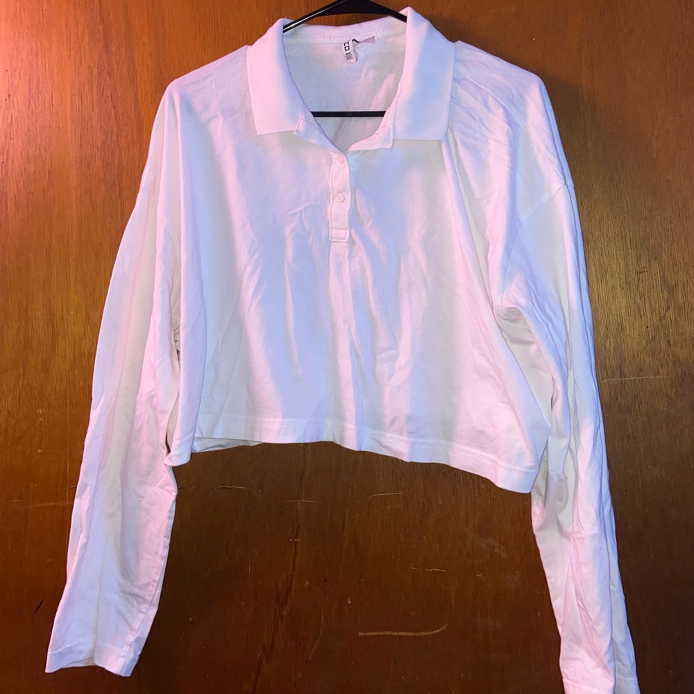 White, collared,  long-sleeved cropped top.